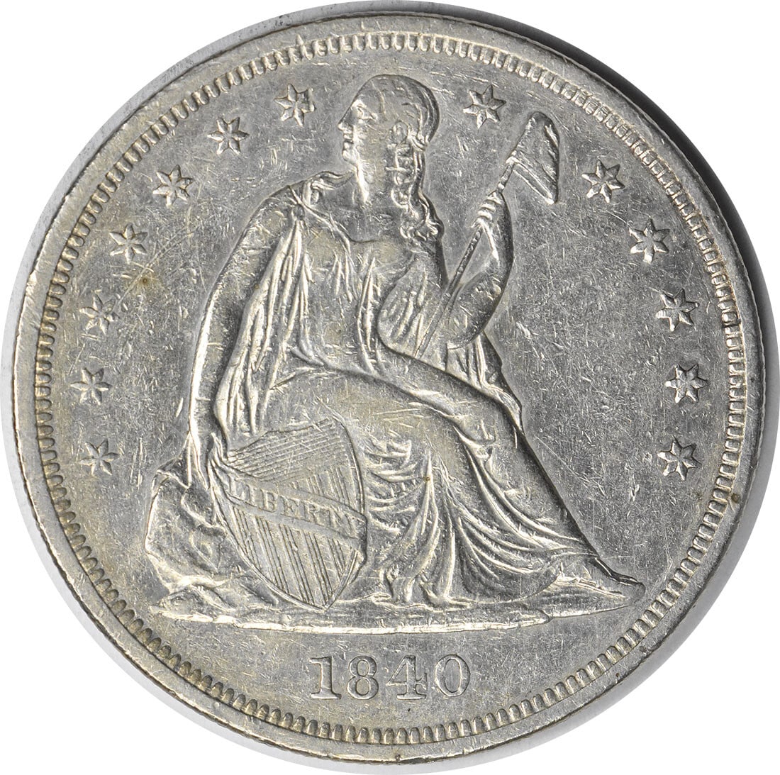 1840 Seated Liberty Dollar 90 Percent Silver AU Uncertified Philadelphia Issue: 1840 Seated Liberty Dollar 90 Percent Silver AU Uncertified Philadelphia Issue This 1840 Liberty Seated Silver Dollar is a pre-owned coin from the United States, minted in Philadelphia. Designed by Ch