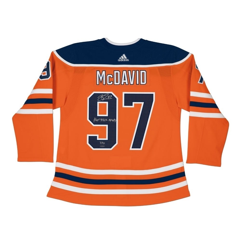 Connor McDavid Autographed Limited Jersey Inscribed Hat Trick Oilers 97: Connor McDavid Autographed Limited Jersey Inscribed Hat Trick Oilers 97 This original Connor McDavid autographed jersey features the inscription "Hat Trick" and is in a vibrant orange color representi