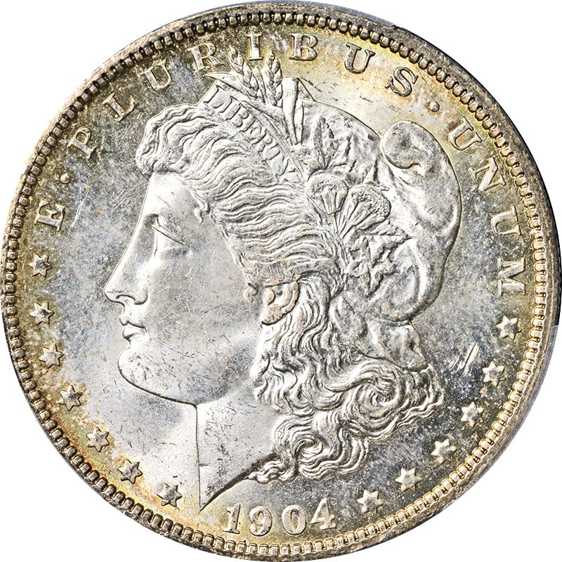 1904-O Morgan Silver Dollar PCGS MS65 Super PQ with Toning: 1904-O Morgan Silver Dollar PCGS MS65 Super PQ with Toning This 1904-O Morgan Silver Dollar is graded PCGS MS65, signifying its uncirculated condition and high quality. The coin features a bright whit