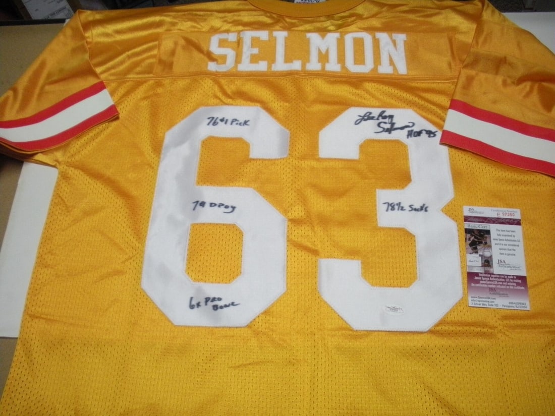 Lee Roy Selmon Signed Tampa Bay Buccaneers Jersey with JSA COA: Lee Roy Selmon Signed Tampa Bay Buccaneers Jersey with JSA COA This officially licensed athletic jersey is a remarkable piece of memorabilia, featuring the signature of Lee Roy Selmon. Ideal for fans