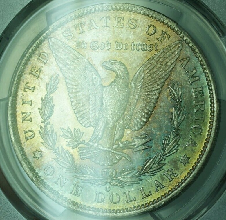 PCGS MS-64 1885-O Morgan Dollar with Attractive Reverse Toning: PCGS MS-64 1885-O Morgan Dollar with Attractive Reverse Toning This is an 1885-O Morgan Silver Dollar graded MS-64 by PCGS. Minted in New Orleans, this uncirculated coin features beautiful reverse ton