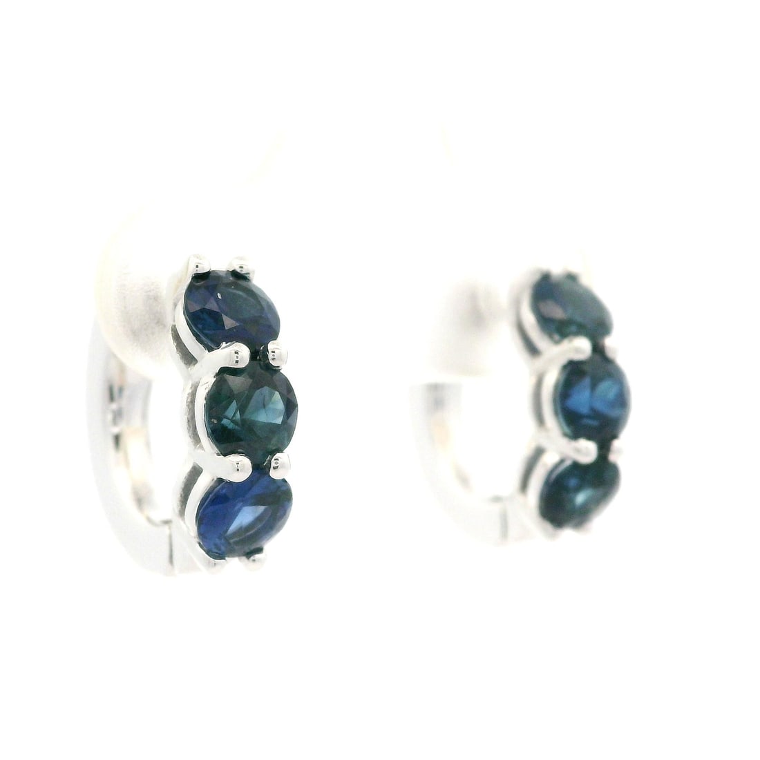 14k White Gold 1.97ctw Blue Sapphire Hoop Huggie Earrings: 14k White Gold 1.97ctw Blue Sapphire Hoop Huggie Earrings These exquisite hoop huggie earrings are crafted from solid 14k white gold, showcasing a stunning total carat weight of 1.97ctw with six natur