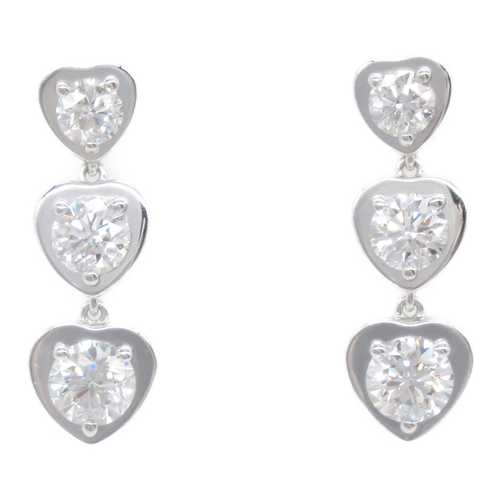 White Gold Heart Pendant by Cartier 20mm x 6.7mm Beige: White Gold Heart Pendant by Cartier 20mm x 6.7mm Beige This Cartier Heart pendant features a feminine design crafted in white gold with a beige accent. The piece has been polished and is in good condi