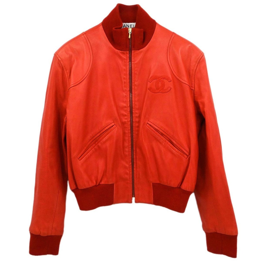 Red Chanel Leather Mid-Length Jacket Size 42 with Zipper Accent: Red Chanel Leather Mid-Length Jacket Size 42 with Zipper Accent This Chanel mid-length jacket features a 100% leather outer shell in red. It is designed with long sleeves, a button closure, single-bre