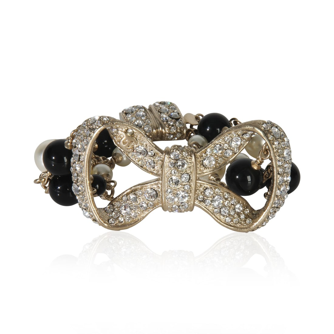 2010 Chanel Strass Bow Gold Plated Bracelet With Bead and Faux Pearl Accents: 2010 Chanel Strass Bow Gold Plated Bracelet With Bead and Faux Pearl Accents This Chanel bracelet from the 2010 Strass Bow collection features an elegant gold-plated design adorned with bead accents a