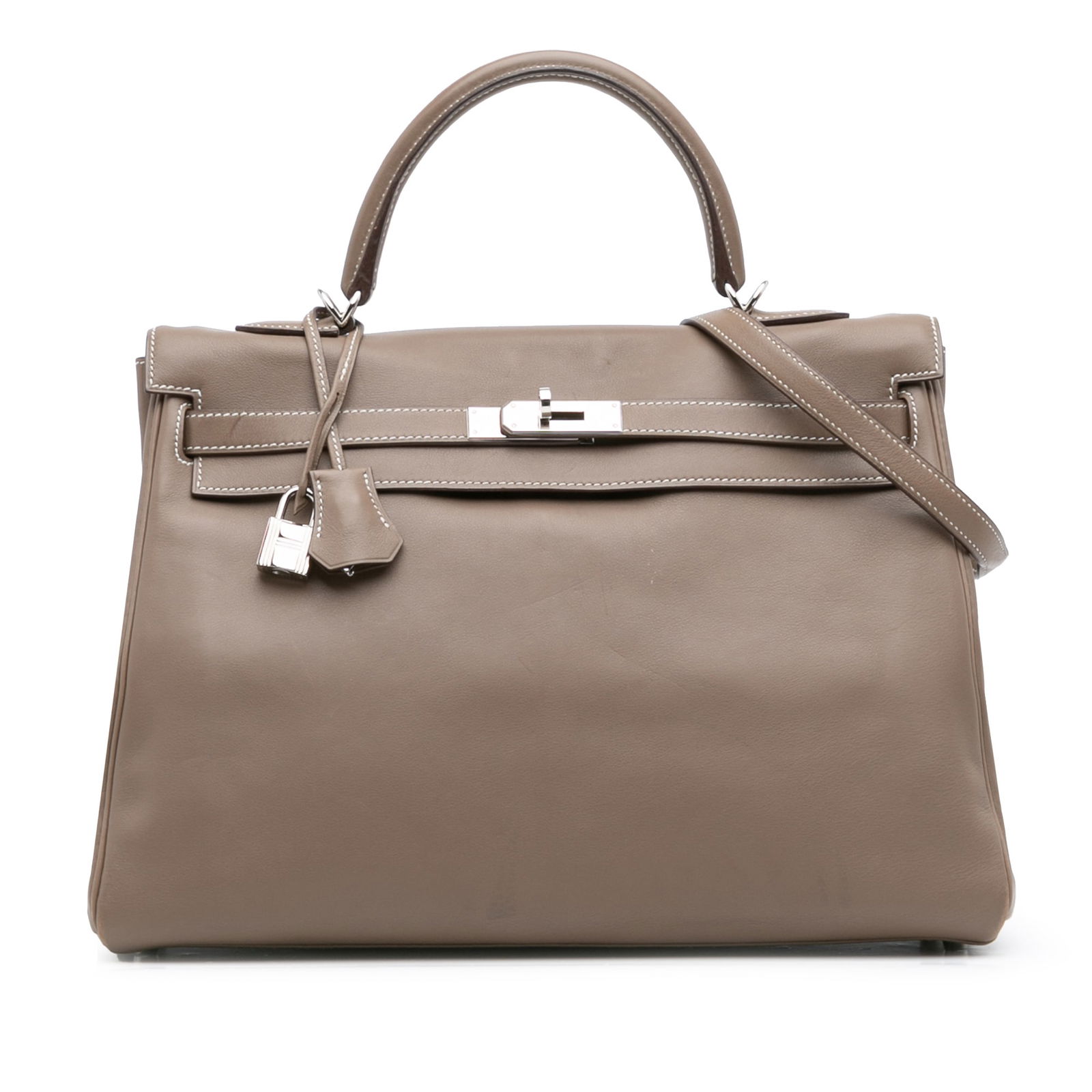 Hermes Swift Kelly II Retourne 35 Etoupe Leather Bag: Hermes Swift Kelly II Retourne 35 Etoupe Leather Bag Introducing the Hermes Swift Kelly II Retourne 35, a stunning bag crafted from premium Swift leather in a sophisticated Etoupe color. This exquisit