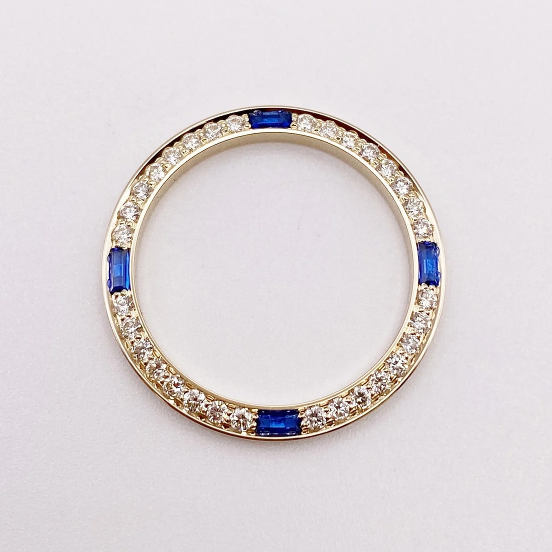 14K Yellow Gold Bezel with .63ct Diamonds and Sapphires for Rolex Datejust: 14K Yellow Gold Bezel with .63ct Diamonds and Sapphires for Rolex Datejust This exquisite 14K Yellow Gold bezel is designed for the Rolex Datejust 26mm models. It features a stunning arrangement of .6