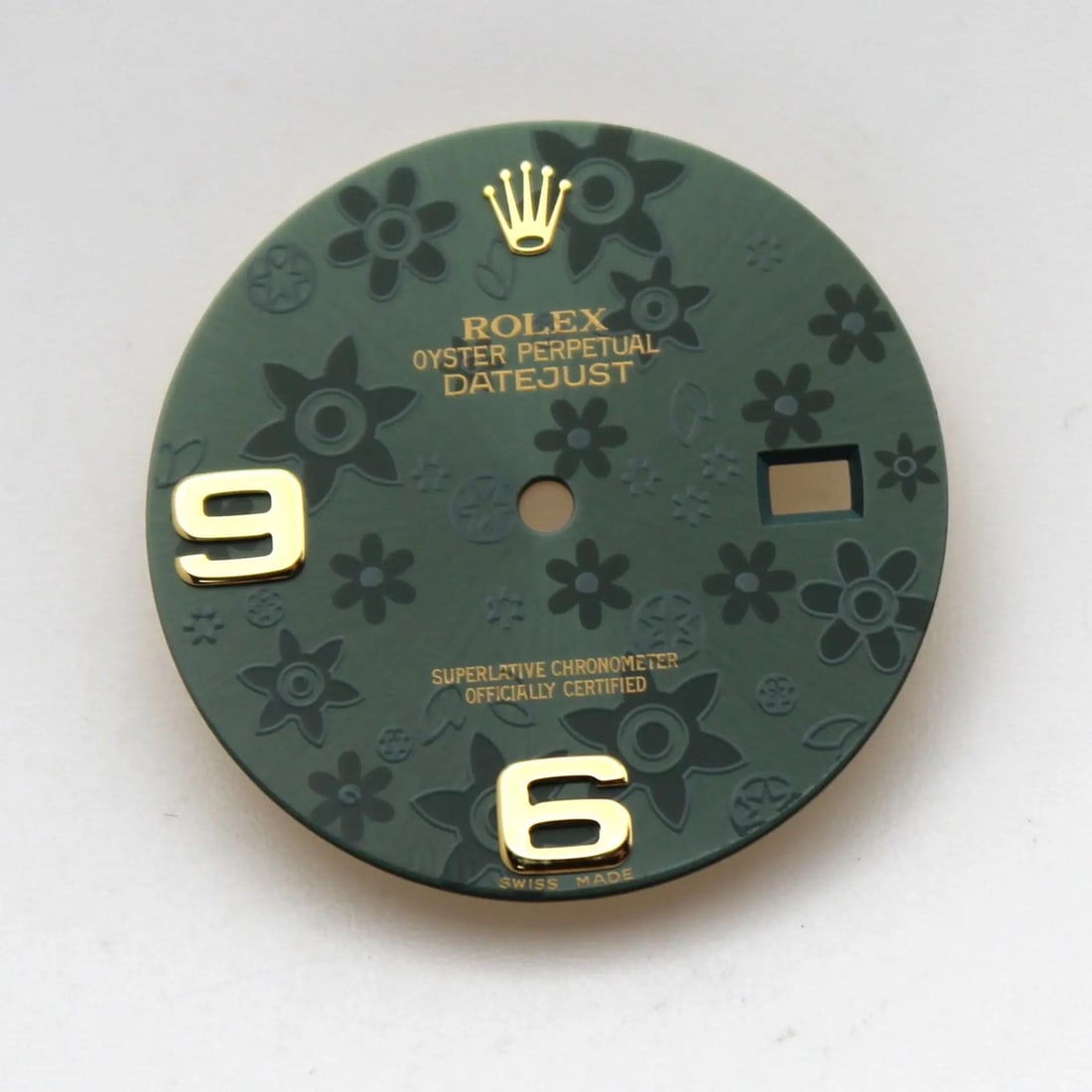 Green Floral Dial With Gold Arabic Numbers For Rolex Datejust 116233: Green Floral Dial With Gold Arabic Numbers For Rolex Datejust 116233 This is a pre-owned Rolex Datejust dial featuring gold Arabic numerals and a green floral motif. Designed in a luxury 12-hour style