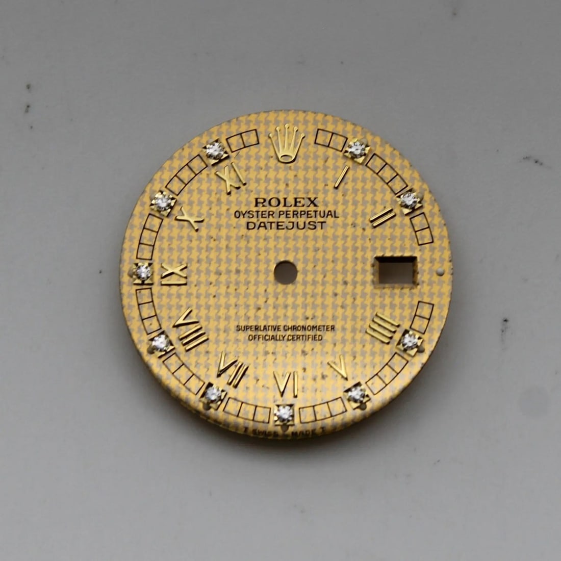 Gold Houndstooth Diamond Dial for Rolex Datejust 16013 16233: Gold Houndstooth Diamond Dial for Rolex Datejust 16013 16233 This is a Rolex Oyster Perpetual Datejust dial featuring a houndstooth pattern with diamond accents. The dial is gold in color and designed