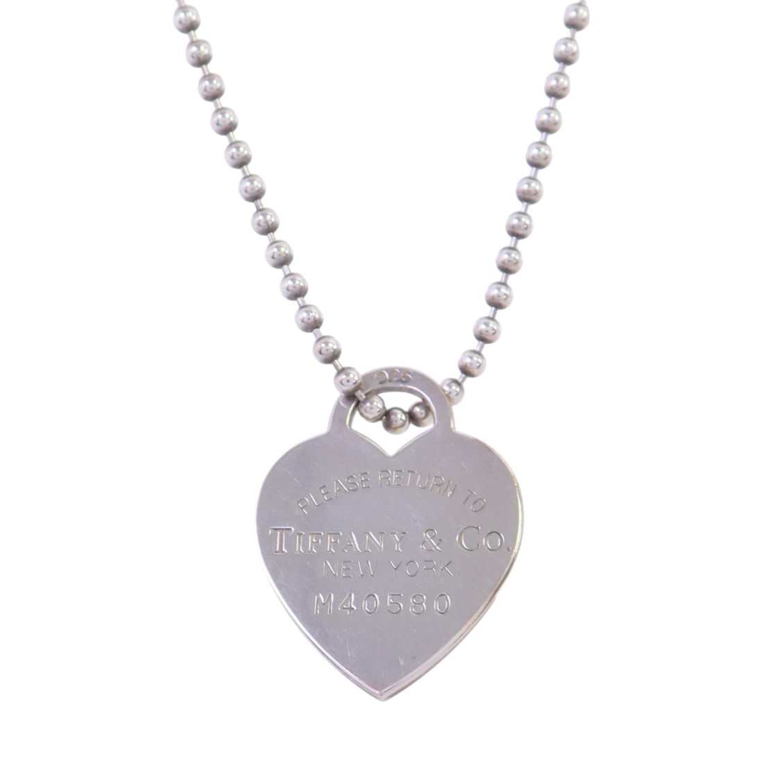 Sterling Silver 925 Heart Pendant Long Necklace by Tiffany & Co: Sterling Silver 925 Heart Pendant Long Necklace by Tiffany & Co This Tiffany & Co. long necklace features a heart design crafted in 925 sterling silver. The piece showcases a silver tone without any s