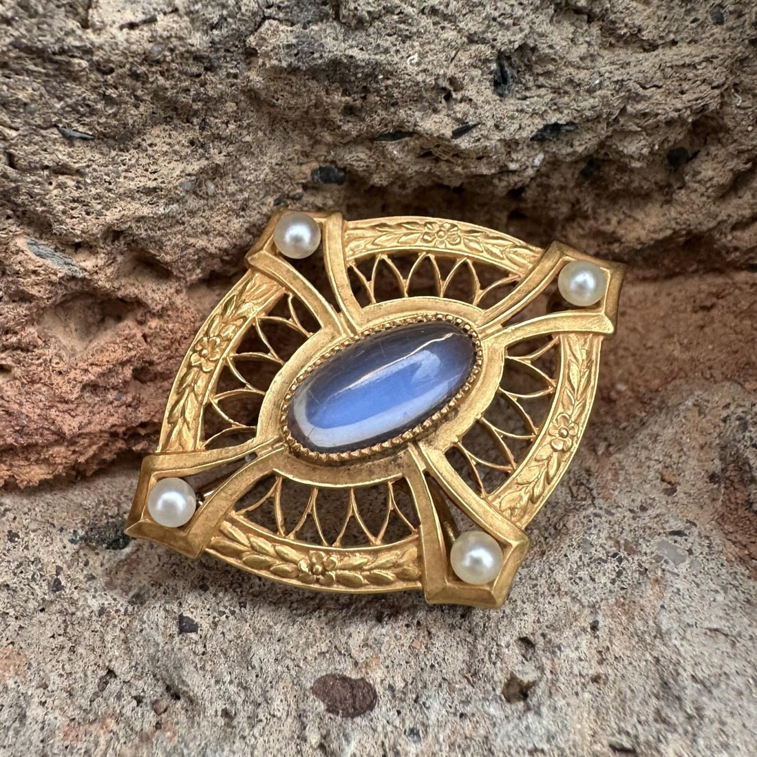 Art Nouveau Era Yellow Gold Brooch with Blue Moonstone and Seed Pearls: Art Nouveau Era Yellow Gold Brooch with Blue Moonstone and Seed Pearls This antique Art Nouveau brooch features a natural blue moonstone in an oval cabochon cut, accented by four cultured seed pearls.