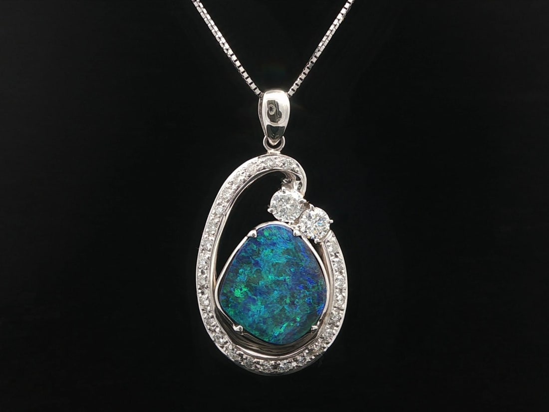 Platinum Pendant Necklace with Boulder Opal and Diamond Accents Adjustable Chain: Platinum Pendant Necklace with Boulder Opal and Diamond Accents Adjustable Chain This elegant necklace features a free form natural boulder opal pendant accented with numerous natural round brilliant