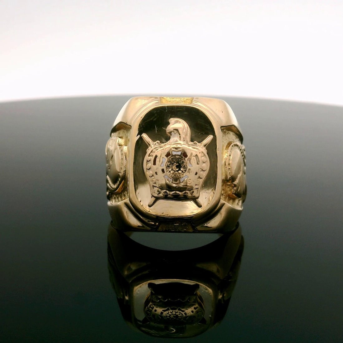 Men's 9k Yellow Gold Enamel Coat of Arms Knight Band Ring: Men's 9k Yellow Gold Enamel Coat of Arms Knight Band Ring This striking men's band ring features a classic coat of arms design in rich 9k yellow gold, complemented by intricate enamel work. The ring,