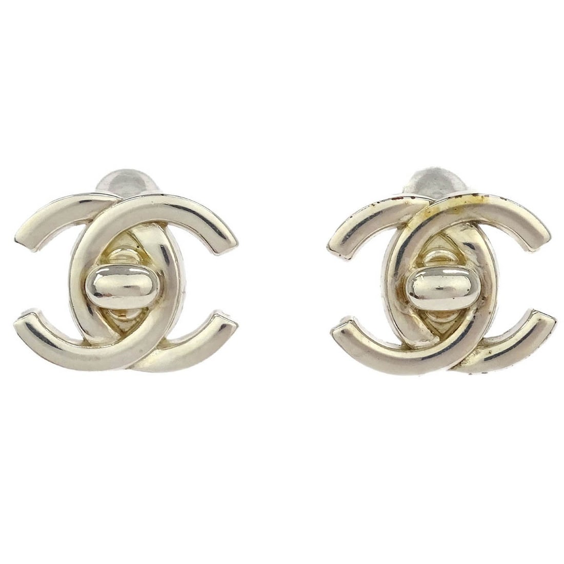 Chanel 96A Silver Turnlock Clip-On Earrings: Chanel 96A Silver Turnlock Clip-On Earrings Add a touch of elegance to your collection with these Chanel CC Turnlock Clip-On Earrings. Crafted with a stylish silver-plated finish, these earrings featu