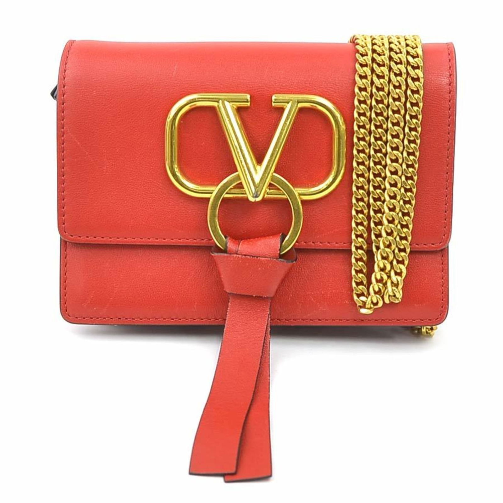 Red Leather Vring Bag by Valentino Garavani Italy: Red Leather Vring Bag by Valentino Garavani Italy The Valentino Garavani Vring is a women's red leather accessory crafted in Italy. It features a compact design with minor signs of use, including ligh
