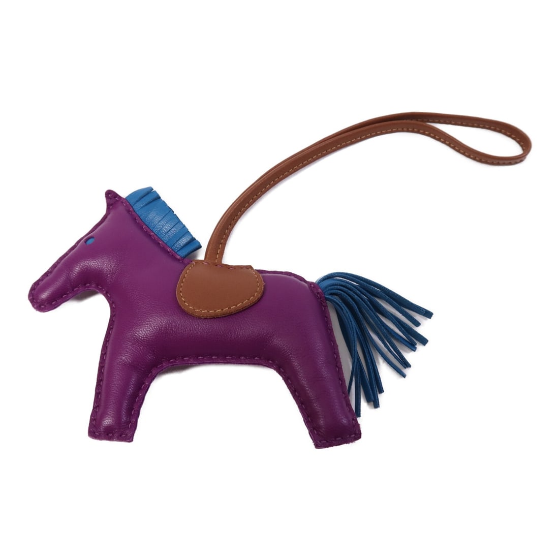 Hermes Rodeo MM Anemone Bleu Izmir Fauve Lambskin Bag Charm: Hermes Rodeo MM Anemone Bleu Izmir Fauve Lambskin Bag Charm This Hermes Rodeo MM charm is crafted from Agneau Milo lambskin leather in a combination of purple, blue, and brown tones. Designed for use