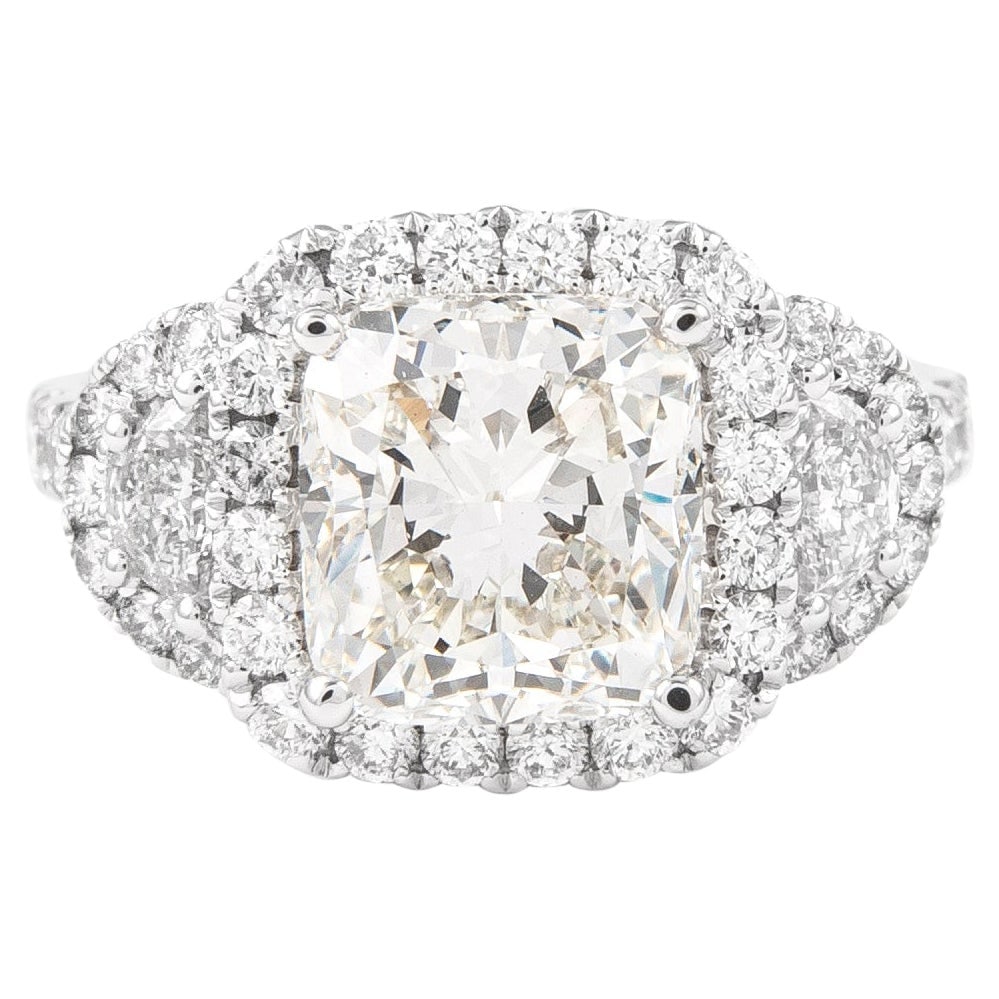 GIA 3.05ct Cushion Cut Diamond Three Stone Ring 18k White Gold: GIA 3.05ct Cushion Cut Diamond Three Stone Ring 18k White Gold This exquisite three-stone engagement ring features a stunning 3.05 ct cushion cut diamond, certified by GIA. The ring is designed in con