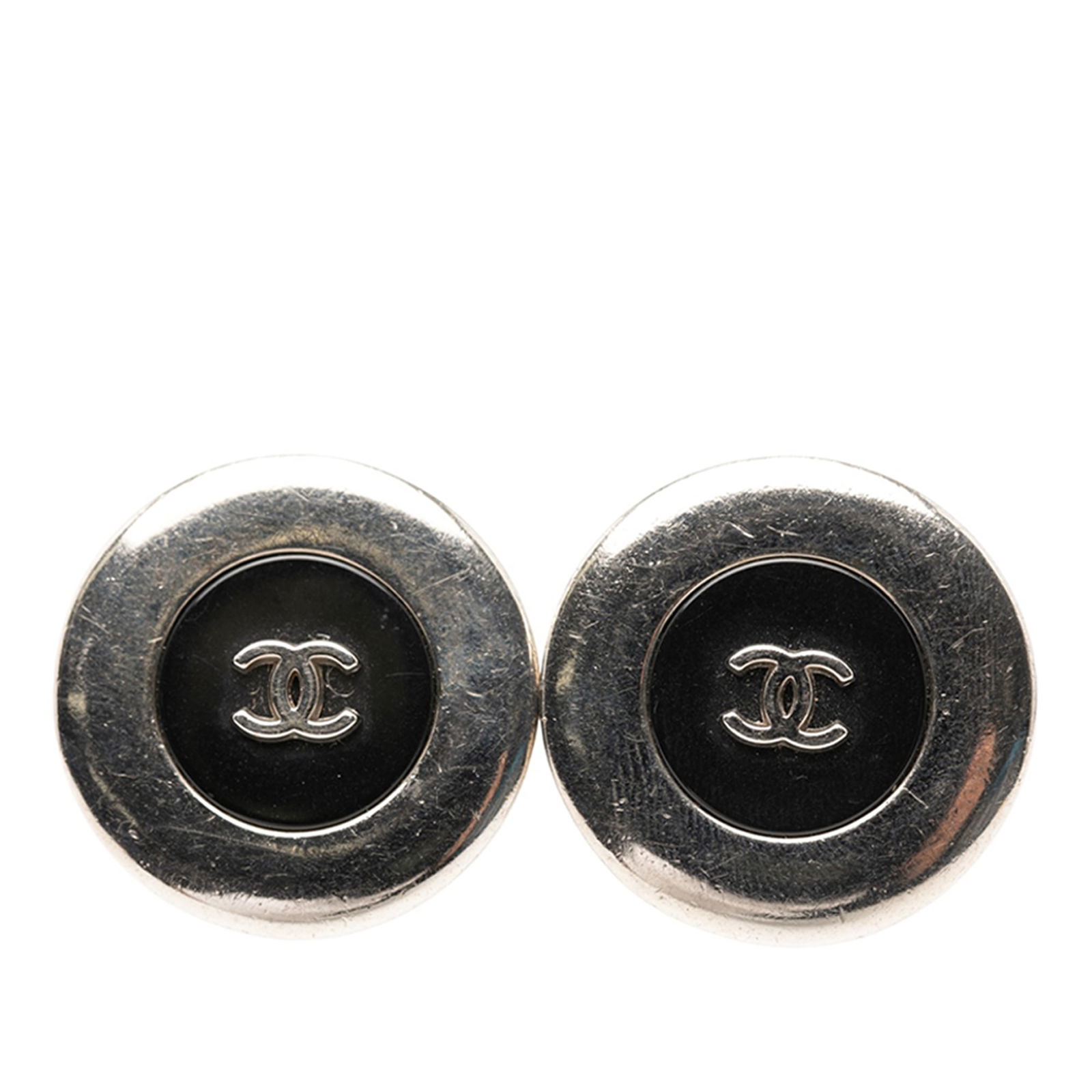 Chanel CC Logo Silver Tone Round Clip On Button Earrings: Chanel CC Logo Silver Tone Round Clip On Button Earrings These Chanel clip-on earrings feature a round button design with the iconic CC logo, crafted from silver tone metal and resin. Made in France,