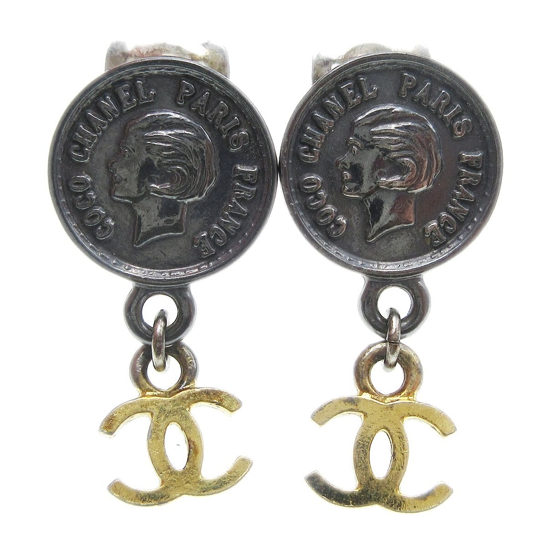 Chanel 96A Gold Silver Medallion Dangle Clip-On Earrings: Chanel 96A Gold Silver Medallion Dangle Clip-On Earrings Elevate your accessory game with these exquisite Chanel Medallion Dangle Earrings. Crafted in a striking combination of gold and silver, these