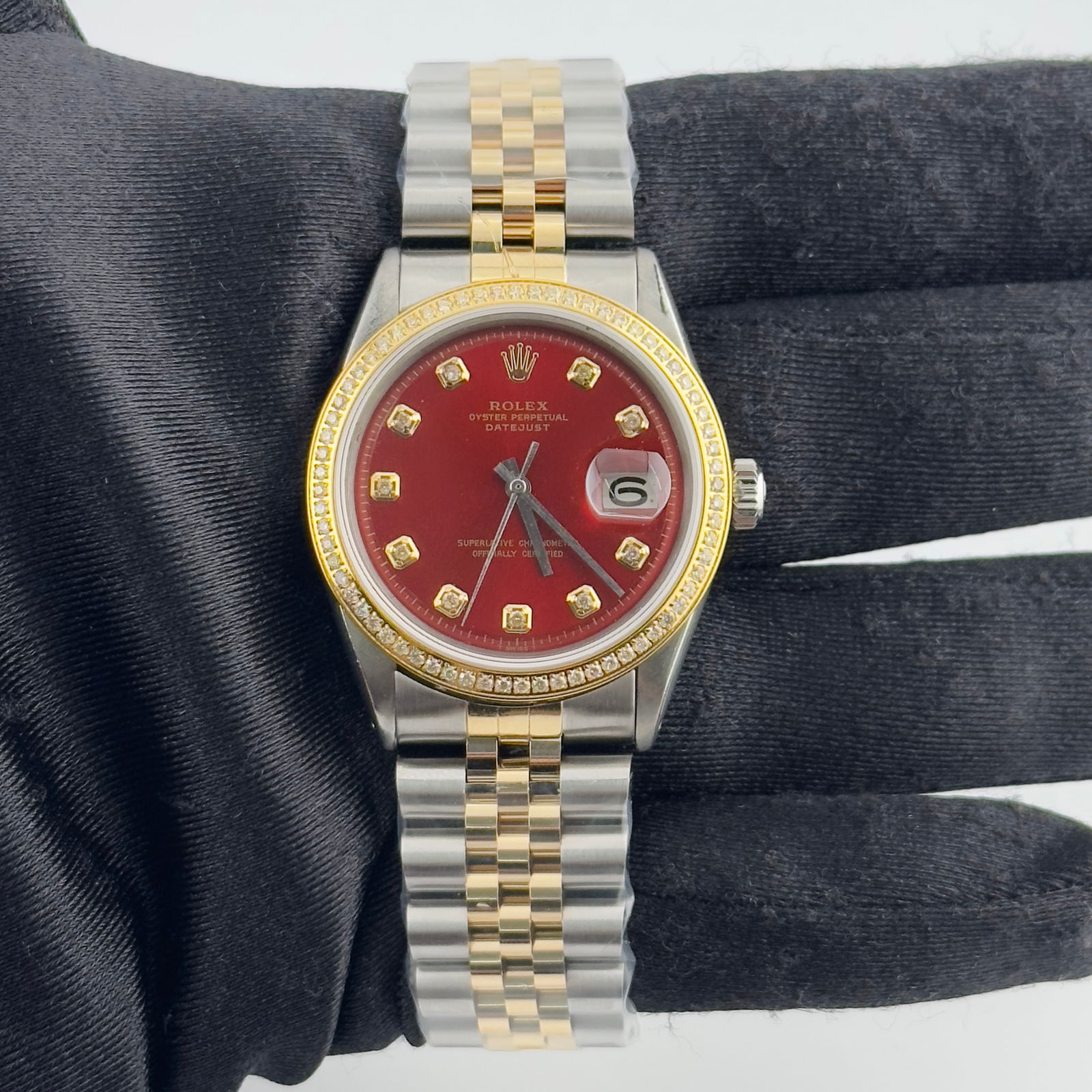 Red Diamond Dial Datejust Ref 1601 with Aftermarket Jubilee Bracelet: Red Diamond Dial Datejust Ref 1601 with Aftermarket Jubilee Bracelet This Rolex Datejust features an aftermarket red diamond dial and an aftermarket Jubilee bracelet. The watch is identified by refere