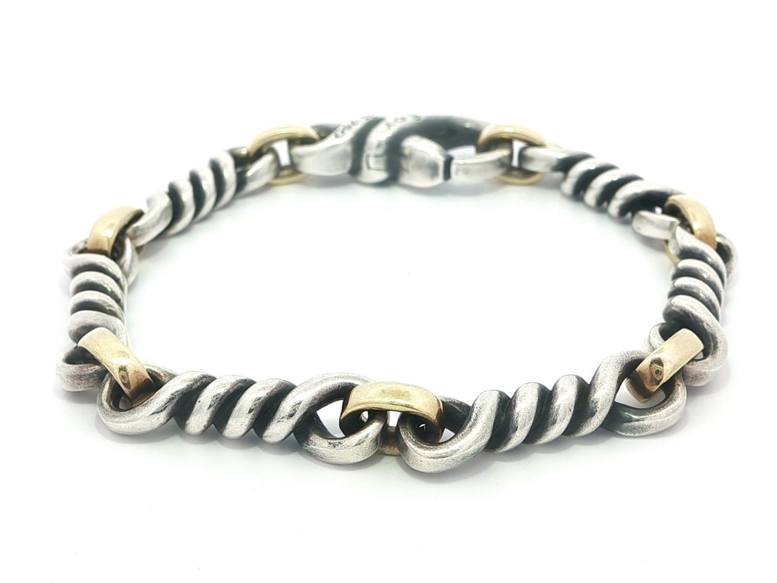 Twisted Link Chain Bracelet in Sterling Silver and 18k Gold by David Yurman: Twisted Link Chain Bracelet in Sterling Silver and 18k Gold by David Yurman This bracelet features a rare twisted link chain design crafted from sterling silver and 18k yellow gold. It is secured with