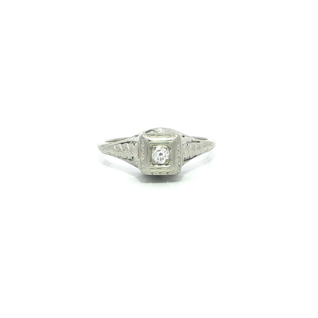 Dainty Antique 18k White Gold Ring with Old European Cut Diamond Solitaire: Dainty Antique 18k White Gold Ring with Old European Cut Diamond Solitaire This antique engagement or promise ring features a dainty, engraved design crafted in solid 18k white gold. It is set with a
