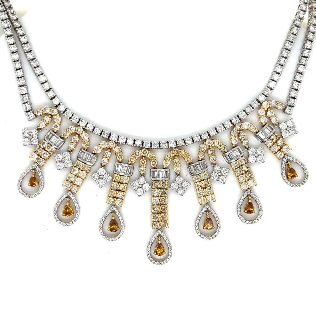 18K Gold Fancy Yellow Diamond Necklace 18.82 Ct with Orange Diamonds: 18K Gold Fancy Yellow Diamond Necklace 18.82 Ct with Orange Diamonds This exquisite necklace features an elegant design crafted from 18K yellow and white gold. It showcases a stunning total of 18.82 c