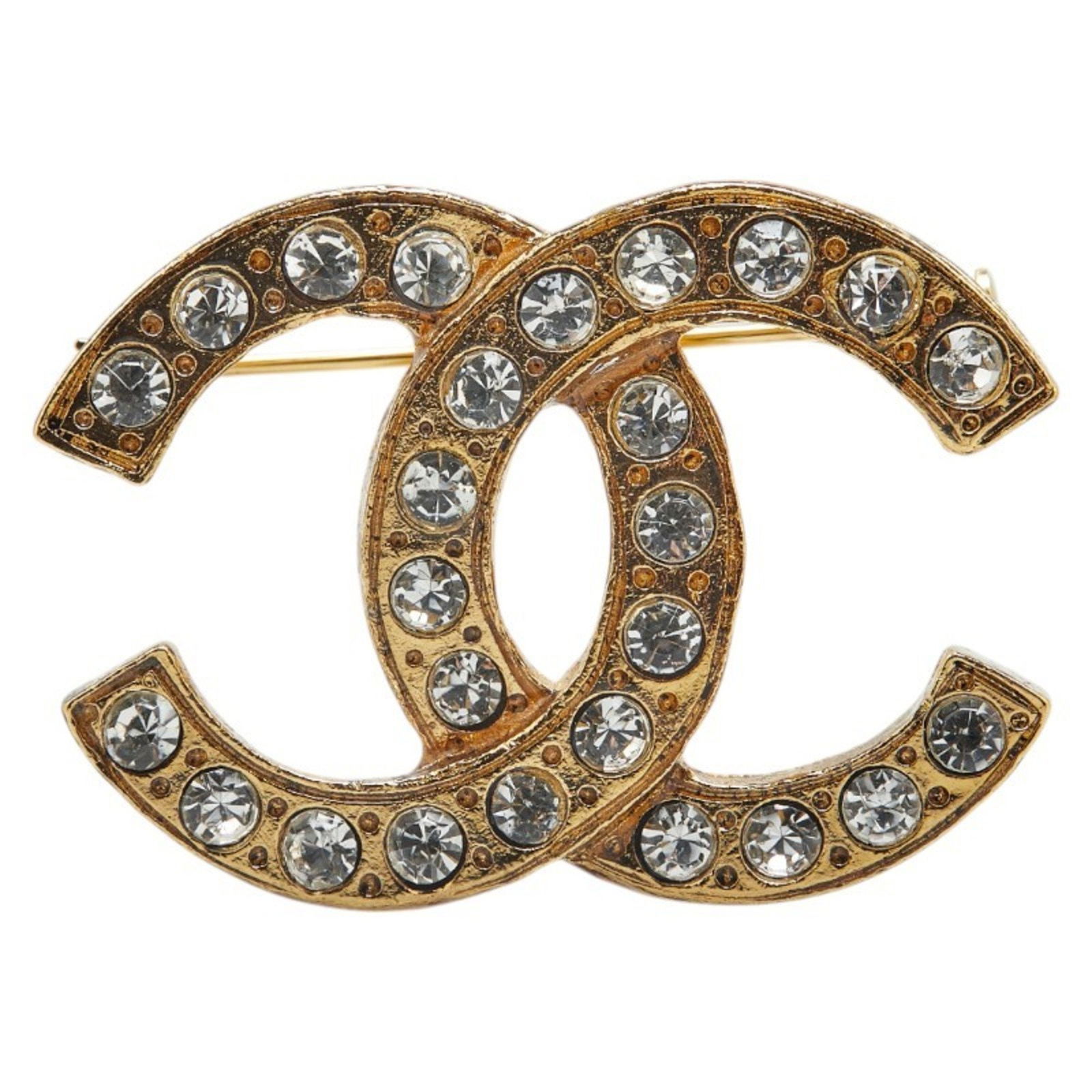 Gold Plated Chanel Coco Mark Brooch with Rhinestone Detail: Gold Plated Chanel Coco Mark Brooch with Rhinestone Detail This Chanel Coco Mark brooch features a gold-plated finish with rhinestone embellishments. Designed for women, it showcases the iconic Chanel