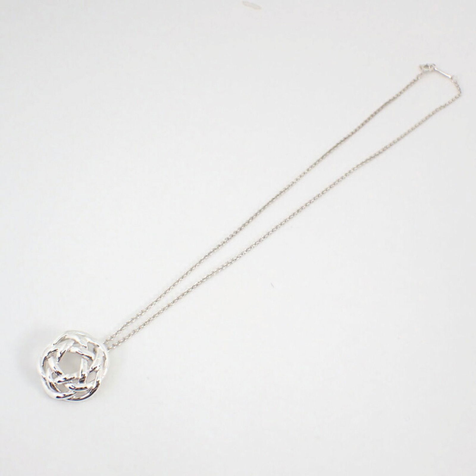 Silver Knot Necklace by Tiffany & Co 41 cm Italian Made: Silver Knot Necklace by Tiffany & Co 41 cm Italian Made This Tiffany & Co. Knot necklace features a silver pendant with a distinctive knot design. Crafted in Italy, it is designed for women and comes