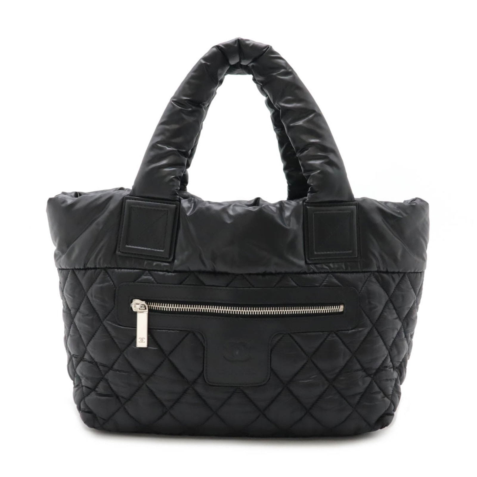 Black Nylon Coco Cocoon Bag by Chanel 23.5cm x 42cm x 16cm: Black Nylon Coco Cocoon Bag by Chanel 23.5cm x 42cm x 16cm The Chanel Coco Cocoon is a women's handbag crafted from black nylon. This model features a spacious design, made in Italy, and includes both