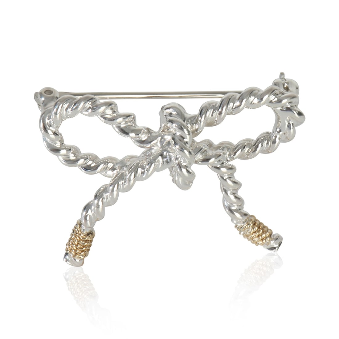 Vintage Bow Brooch in 18k Yellow Gold and Sterling Silver by Tiffany & Co.: Vintage Bow Brooch in 18k Yellow Gold and Sterling Silver by Tiffany & Co. This vintage Tiffany & Co. brooch from the Vintage Bow collection is crafted from 18k yellow gold and sterling silver. Design