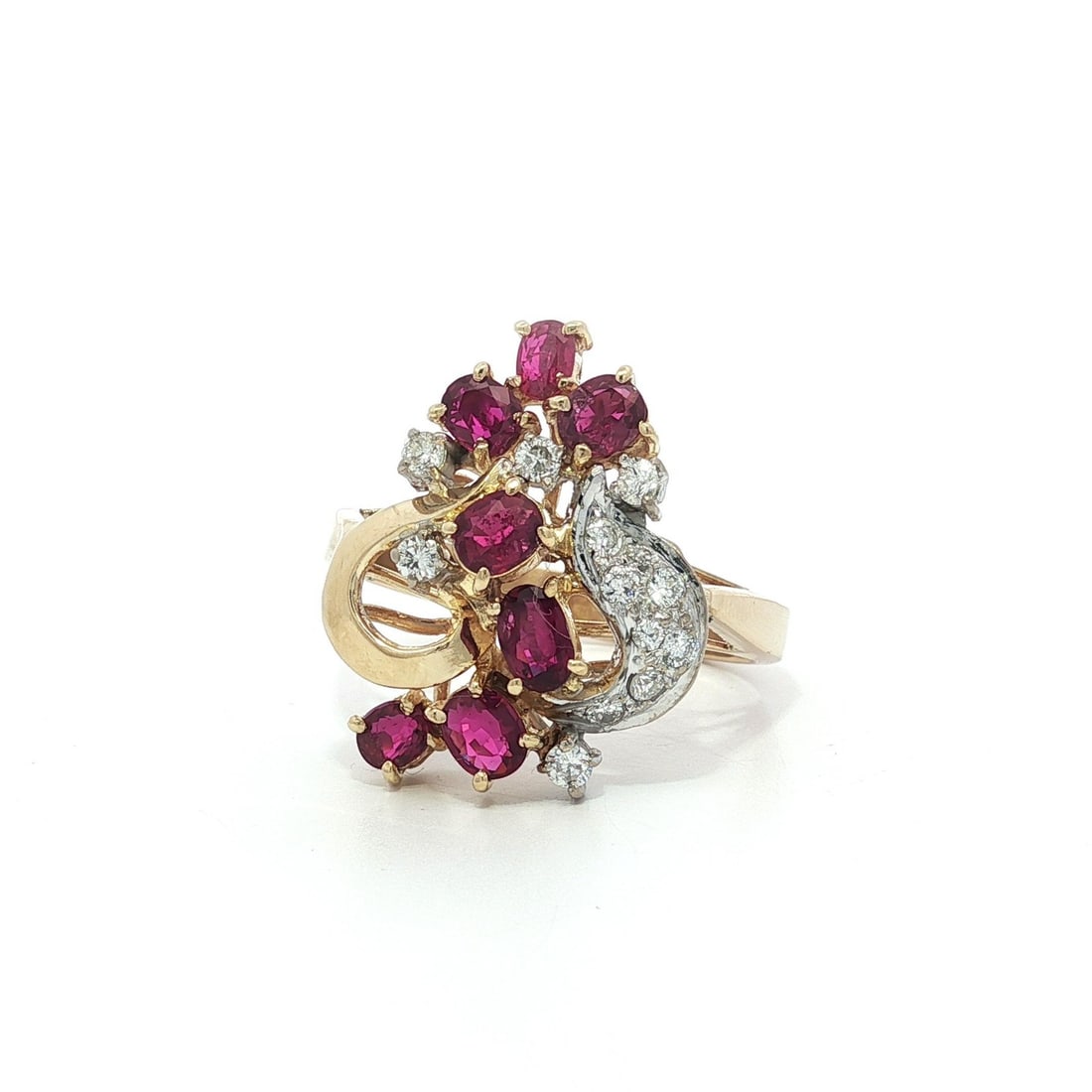 18k Gold 1.60ctw Ruby Diamond Heart Cluster Ring: 18k Gold 1.60ctw Ruby Diamond Heart Cluster Ring This exquisite cocktail ring features a stunning open heart design adorned with a rich red oval ruby and sparkling diamonds. The focal stone is a natur