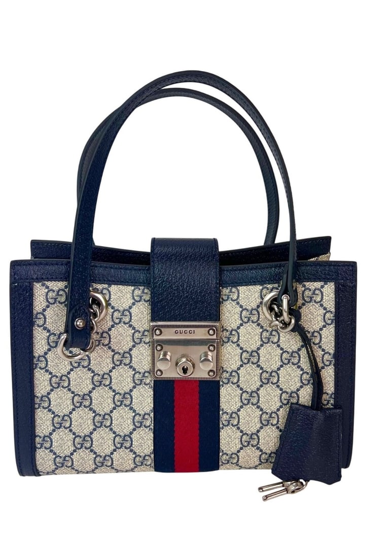 Gucci Padlock Navy GG Supreme Calfskin Web Small Tote: Gucci Padlock Navy GG Supreme Calfskin Web Small Tote This stunning Gucci GG Supreme Dollar Calfskin Web Small Padlock Tote combines luxury and functionality in a timeless design. Crafted from durable