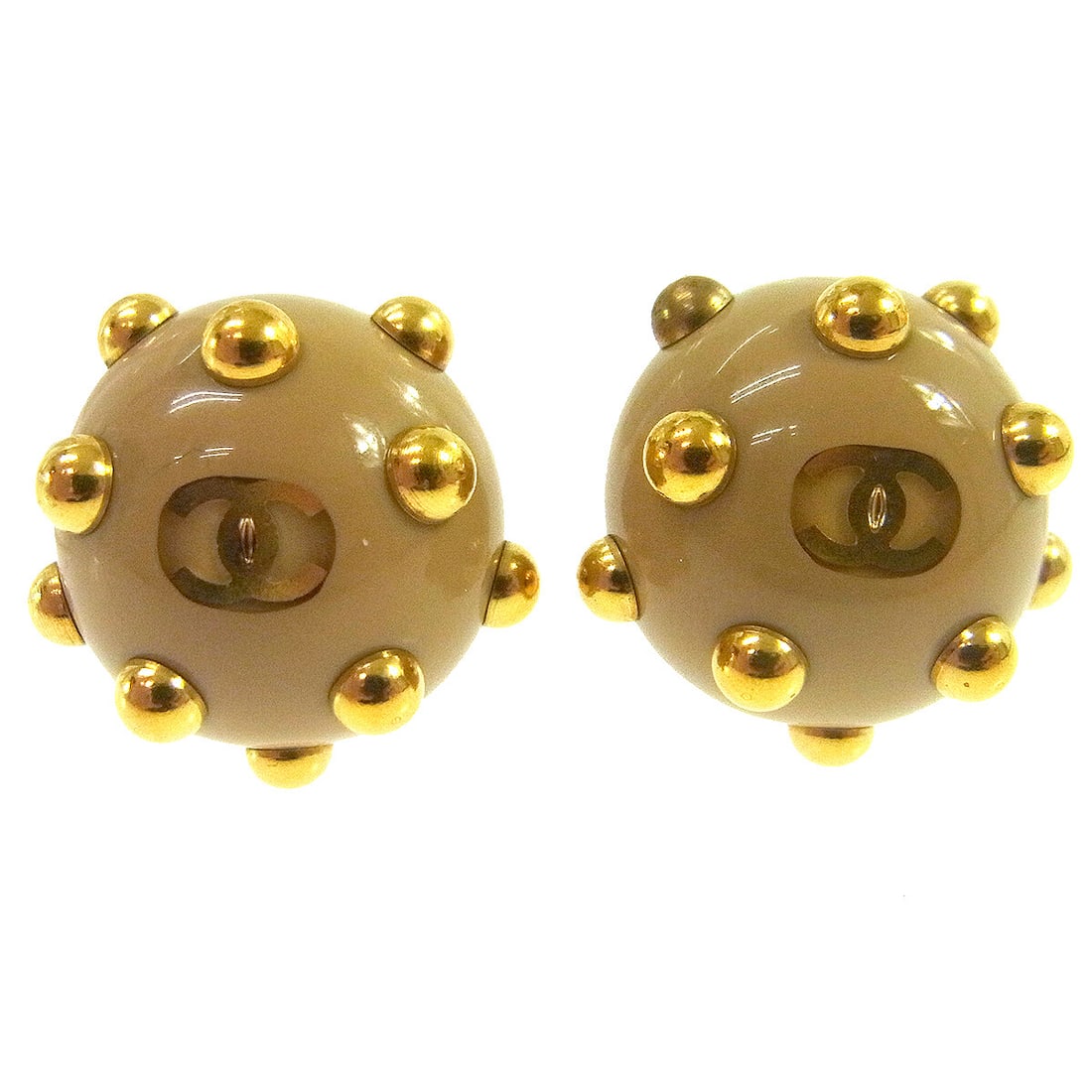 Chanel 00A Beige Gold-tone Studded Clip-On Earrings: Chanel 00A Beige Gold-tone Studded Clip-On Earrings Elevate your accessory game with these exquisite Chanel Studded Button Clip-On Earrings. Crafted in France, these earrings showcase a chic beige col