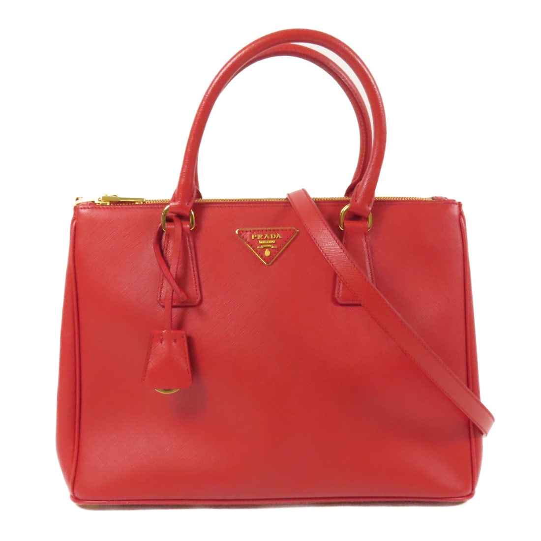 PRADA 2way Shoulder Bag Saffiano Leather Red GHW Made in Italy: PRADA 2way Shoulder Bag Saffiano Leather Red GHW Made in Italy This stunning PRADA 2way shoulder bag is crafted from luxurious Saffiano leather in a vibrant red hue. The bag features a versatile desig