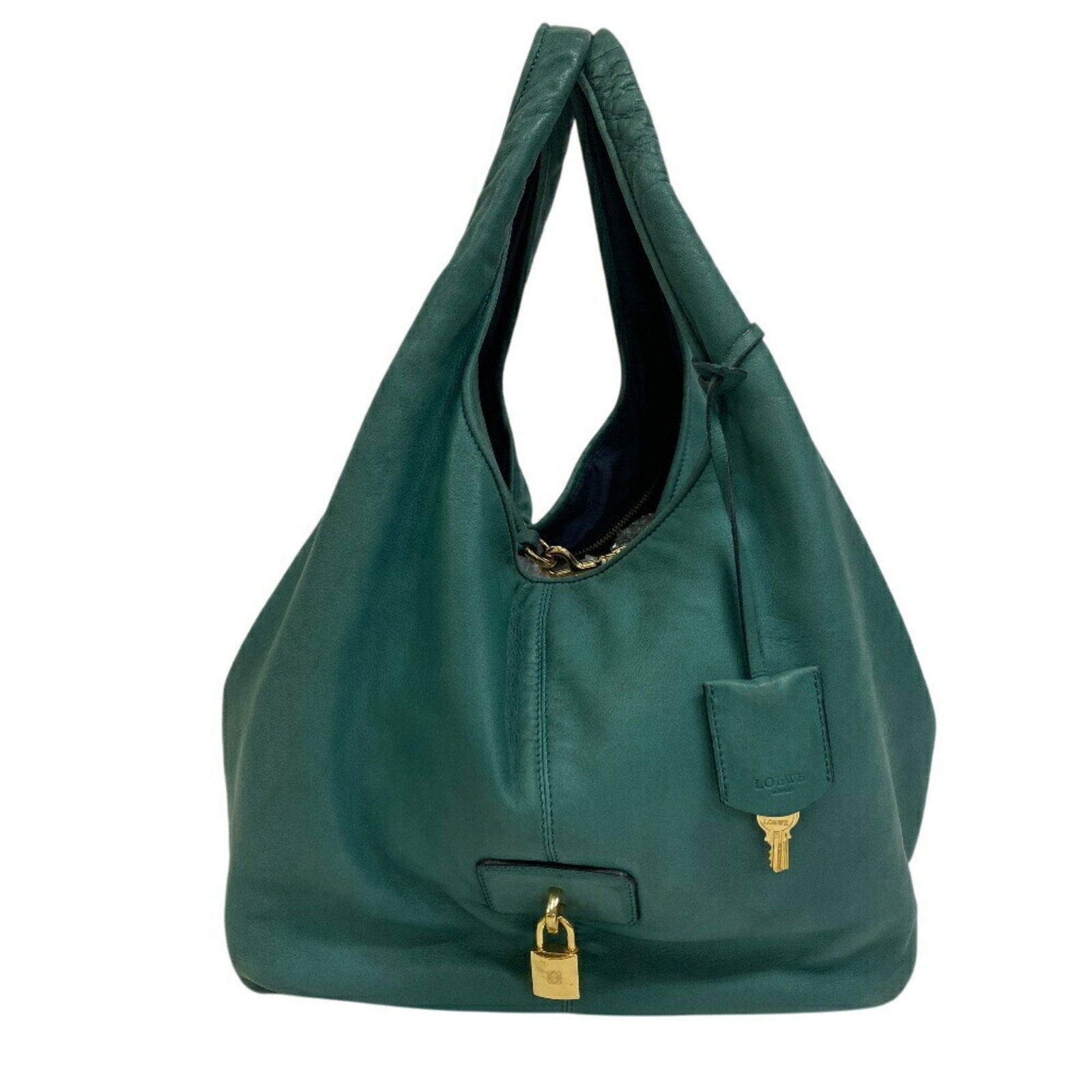 Green Leather Carrier Bag by Loewe 27cm x 34cm x 24cm: Green Leather Carrier Bag by Loewe 27cm x 34cm x 24cm This Loewe Carrier bag is crafted from green leather and features a spacious design. It is designed for women and originates from Spain. The bag s