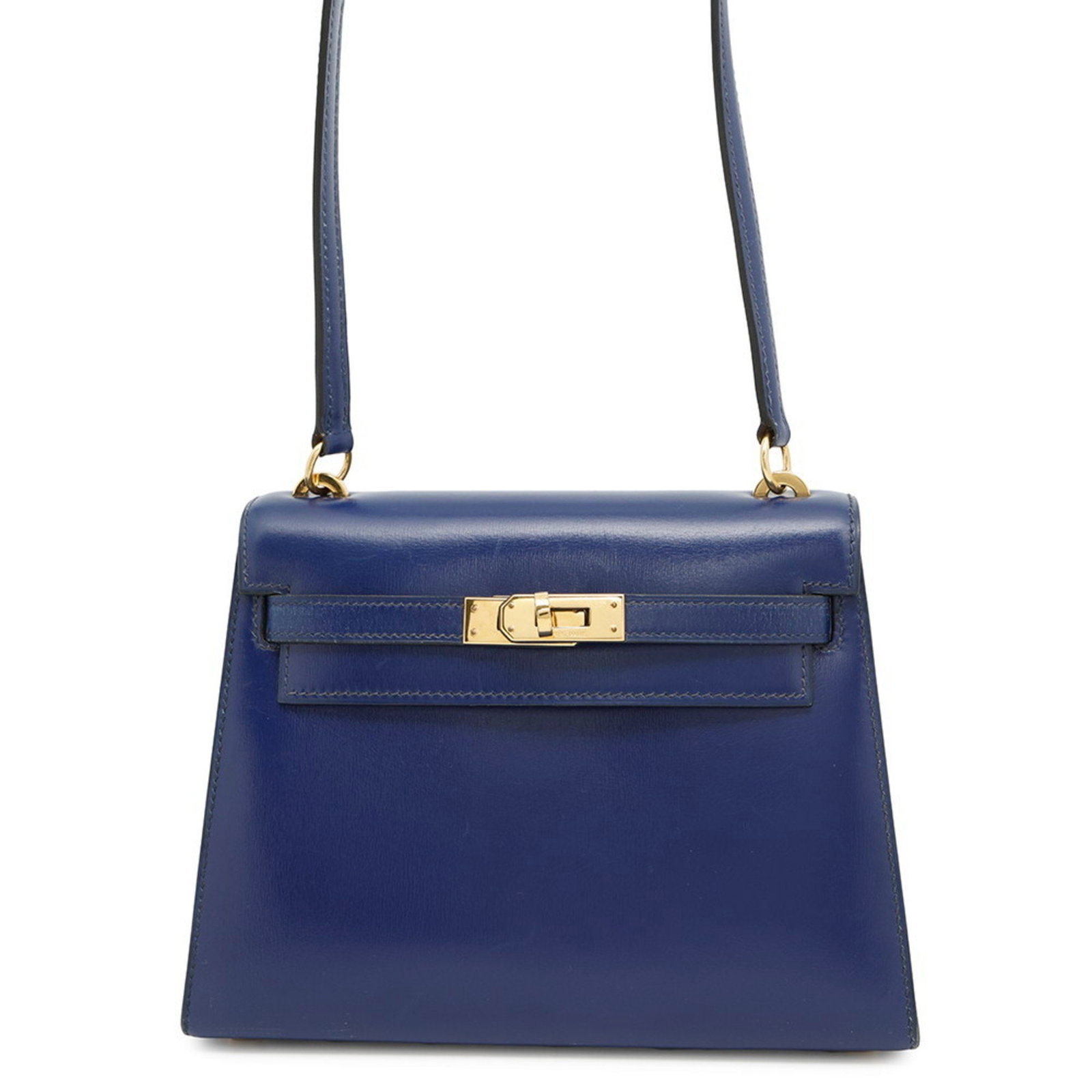 Hermes Kelly Mini Navy Leather Bag 20 cm France: Hermes Kelly Mini Navy Leather Bag 20 cm France This Hermes Kelly Mini is crafted from navy leather and features a compact design. It has metal fittings with slight discoloration and minor scratches.