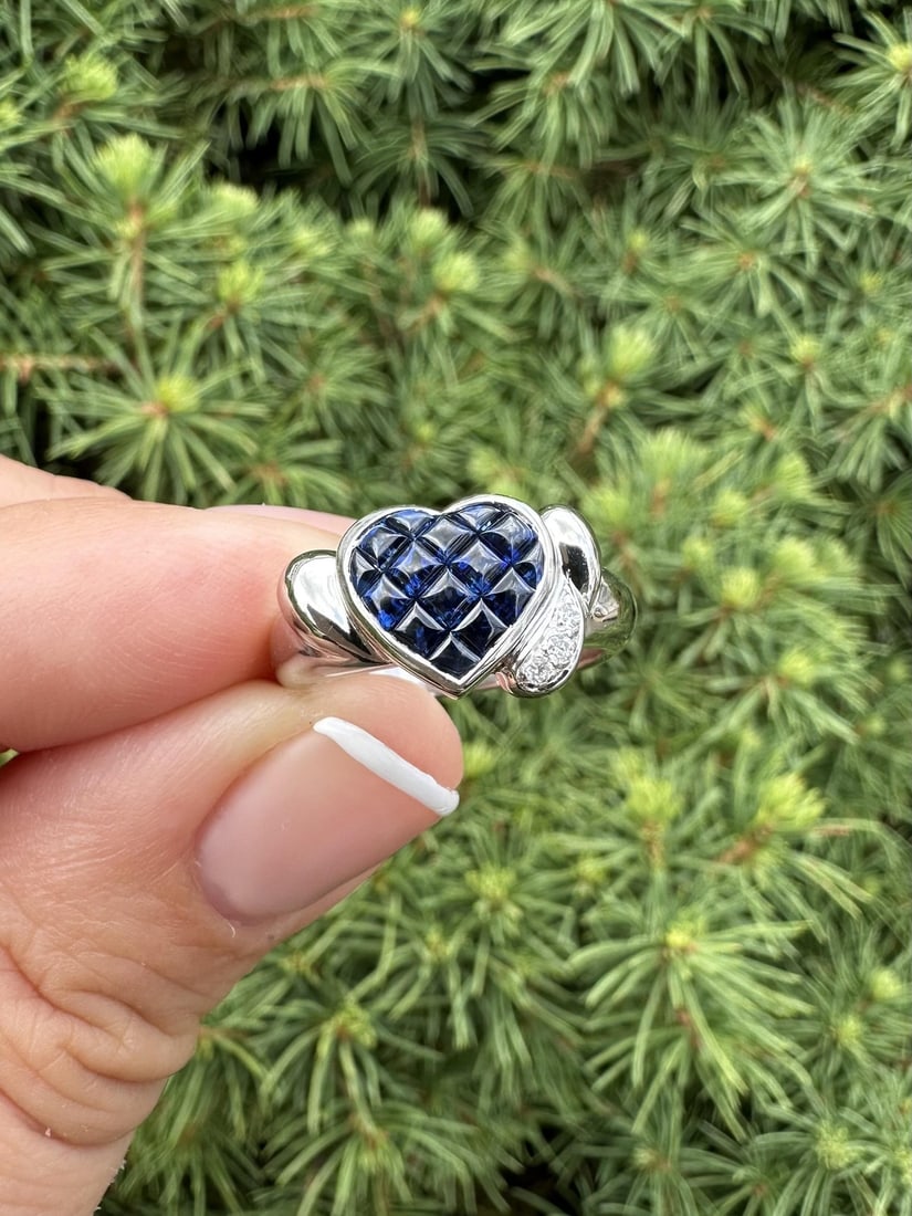 Platinum Invisible Set Sapphire Diamond Heart Band Ring 1.1ct: Platinum Invisible Set Sapphire Diamond Heart Band Ring 1.1ct This stunning band ring features a heart-shaped design adorned with natural, calibre cut cabochon sapphires and diamonds. The deep blue sa