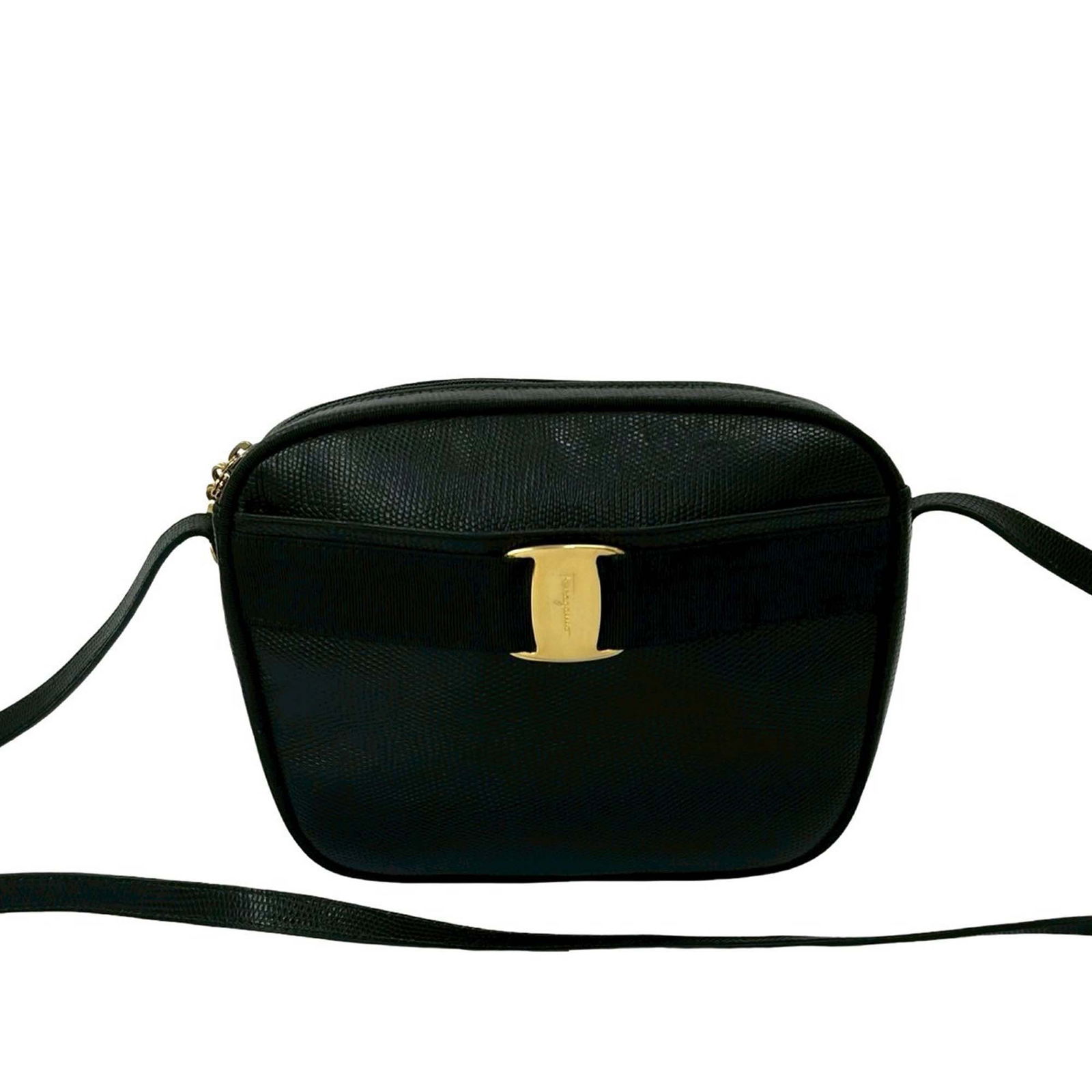 Black Embossed Lizard Leather Vara Crossbody Bag by Ferragamo: Black Embossed Lizard Leather Vara Crossbody Bag by Ferragamo This Ferragamo crossbody bag is crafted from embossed lizard-pattern leather in black. It features a flat leather shoulder strap, a top zi