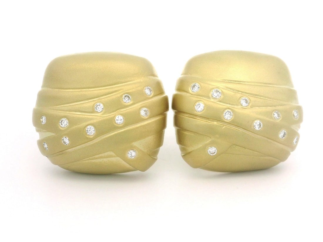 Omega 18K Yellow Gold 0.44ctw Diamond Matte Cushion Button Earrings: Omega 18K Yellow Gold 0.44ctw Diamond Matte Cushion Button Earrings These exquisite earrings feature a beautiful cushion button design crafted from solid 18K yellow gold. Each earring is adorned with