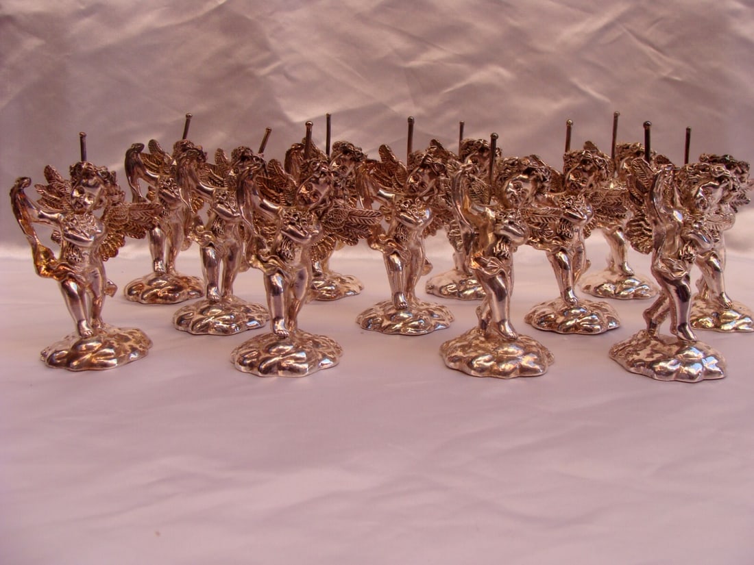 12 Sterling Silver Overlay Cherub Card Holders Set: 12 Sterling Silver Overlay Cherub Card Holders Set This exquisite collection features 12 pieces of sterling silver overlay cherub card holders, showcasing exceptional detail, design, and craftsmanship