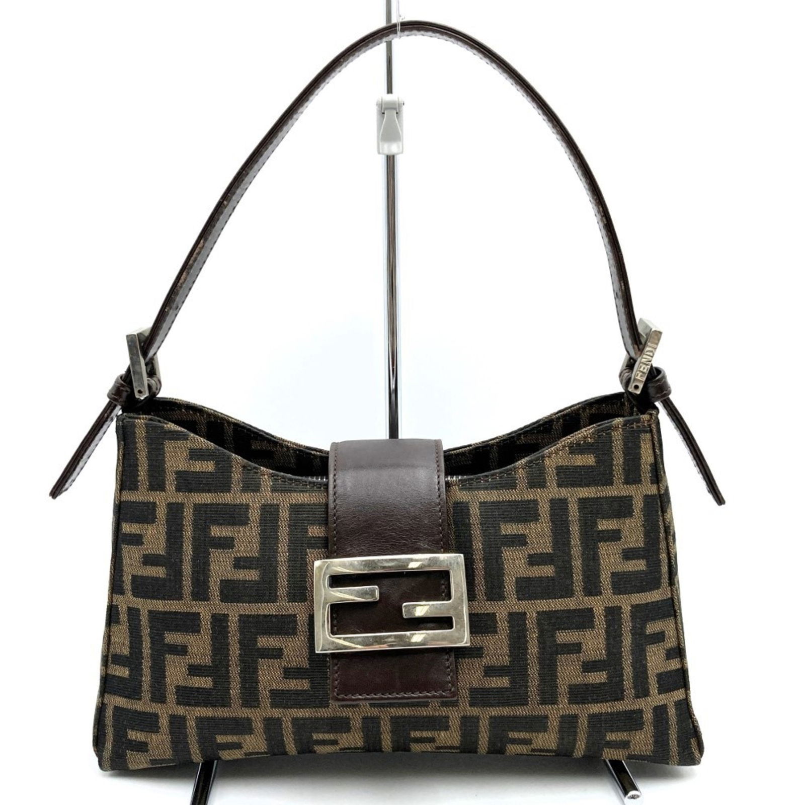 Fendi Zucca Brown Canvas Handbag for Women 15cm x 26cm x 8cm: Fendi Zucca Brown Canvas Handbag for Women 15cm x 26cm x 8cm The Fendi Zucca handbag is designed for women and features a brown canvas exterior. Originating from Italy, this bag combines sophisticatio