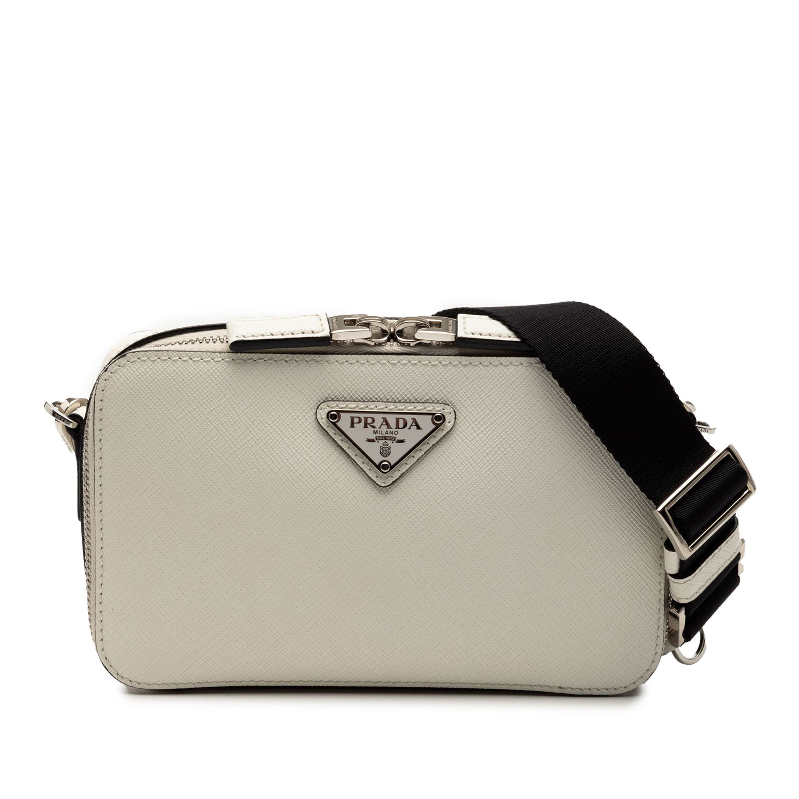White Prada Saffiano Leather Brique Crossbody Bag with Canvas Strap: White Prada Saffiano Leather Brique Crossbody Bag with Canvas Strap This Prada Saffiano Brique Crossbody features a saffiano leather body in white, a detachable flat canvas strap, and a top zip closur