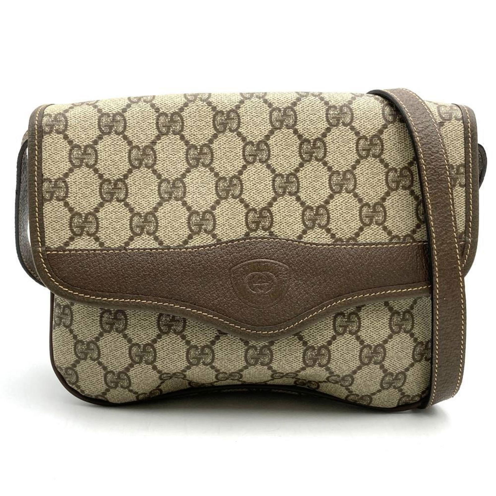 Brown Canvas GG Supreme Shoulder Bag by Gucci Italy: Brown Canvas GG Supreme Shoulder Bag by Gucci Italy This Gucci GG Supreme bag features a brown canvas construction and a classic silhouette designed for women. It offers a spacious main compartment an
