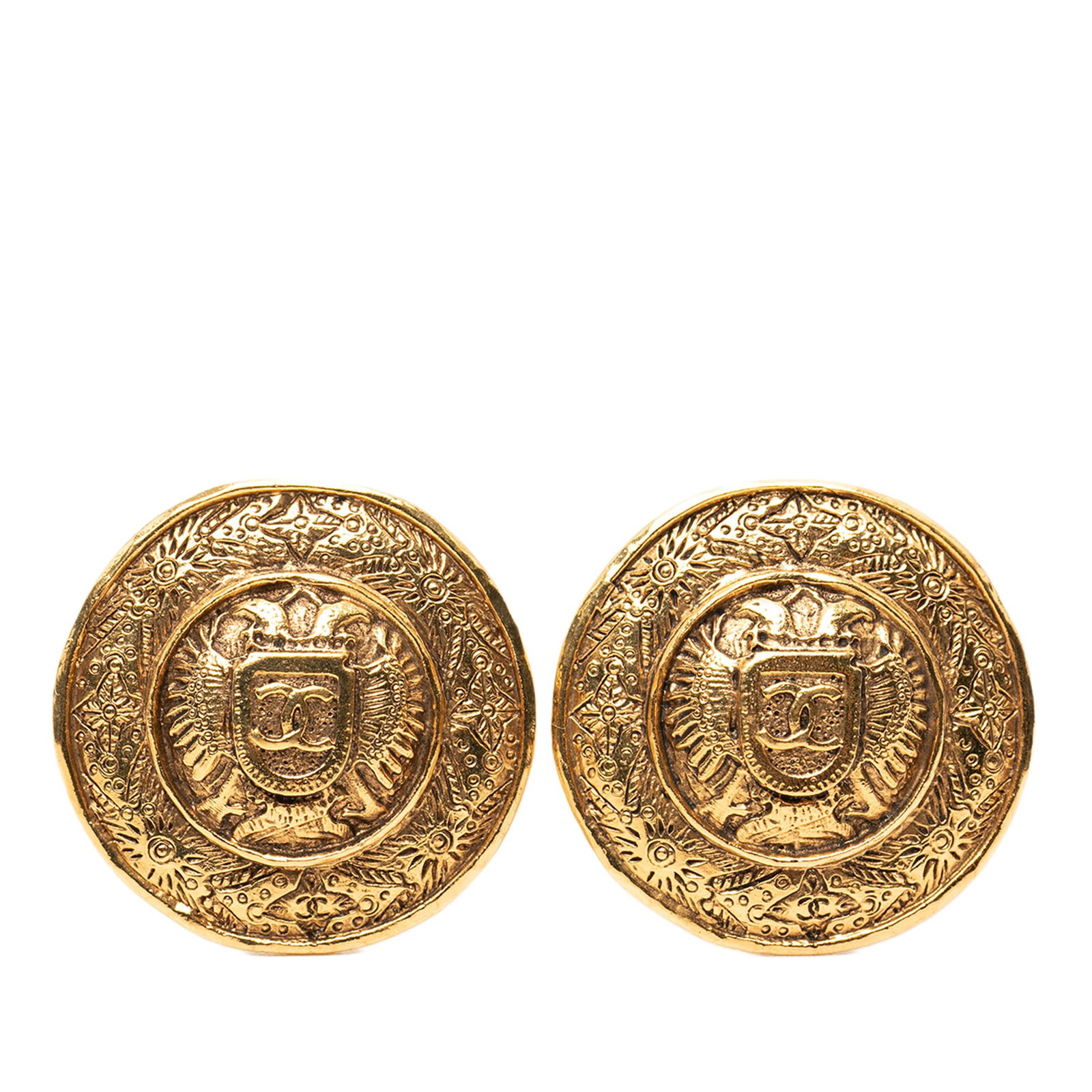 Chanel Crest Round Gold Plated Clip Earrings: Chanel Crest Round Gold Plated Clip Earrings These Chanel earrings feature a round design with a gold-plated metal body and a clip-on back closure. The earrings are classified as costume jewelry and d