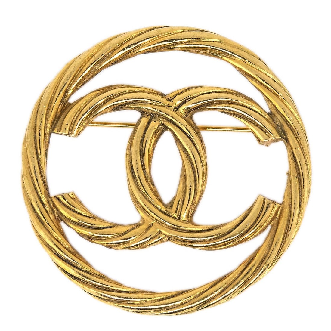 Gold Plated Round Brooch by Chanel Medallion Design: Gold Plated Round Brooch by Chanel Medallion Design This Chanel medallion brooch features a classic round shape with a gold-plated finish. The brooch showcases the unmistakable Chanel design and was c