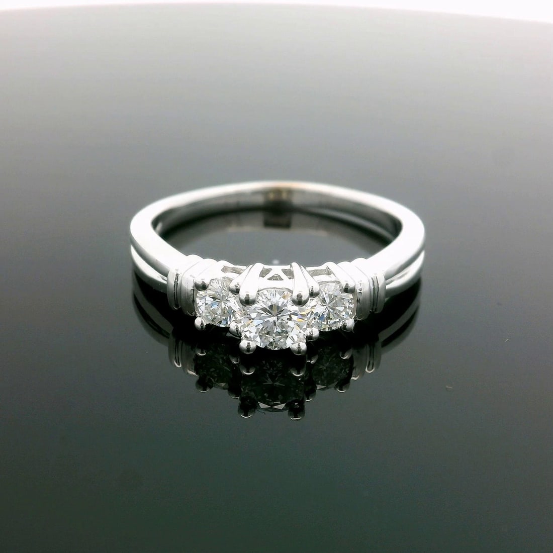 14k White Gold Three Stone Diamond Engagement Ring 0.65ctw: 14k White Gold Three Stone Diamond Engagement Ring 0.65ctw This exquisite 14k white gold ring features a stunning trio of natural genuine diamonds, each expertly crafted in a round brilliant cut. With