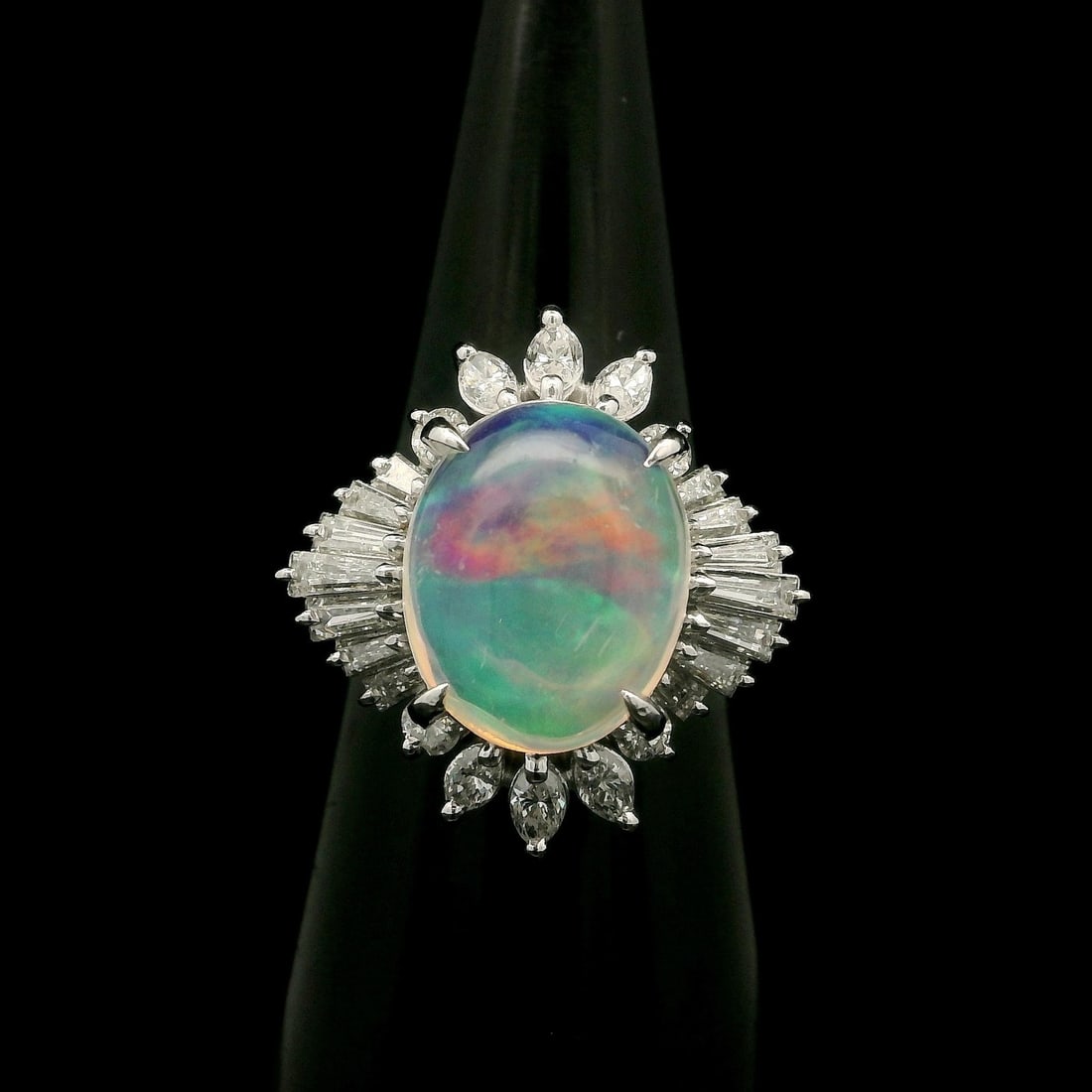 Platinum 3.43ctw Oval Jelly Opal and Diamond Ballerina Cocktail Ring: Platinum 3.43ctw Oval Jelly Opal and Diamond Ballerina Cocktail Ring Make a stunning statement with this exquisite Platinum 3.43ctw Oval Fiery Jelly Opal with Diamond Ballerina Ring. The centerpiece i