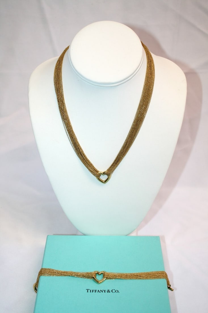Tiffany & Co 18K Yellow Gold Heart Necklace Bracelet Set with Bag and Box: Tiffany & Co 18K Yellow Gold Heart Necklace Bracelet Set with Bag and Box This exquisite Tiffany & Co. set features an 18K yellow gold heart necklace and bracelet, showcasing impeccable craftsmanship