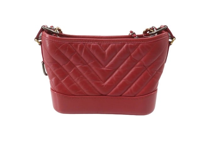 Red Leather Chanel Gabrielle Shoulder Bag Made in Italy: Red Leather Chanel Gabrielle Shoulder Bag Made in Italy This Chanel Gabrielle bag is crafted from red leather and features a unique size. The bag is made in Italy and is designed for women. The exteri